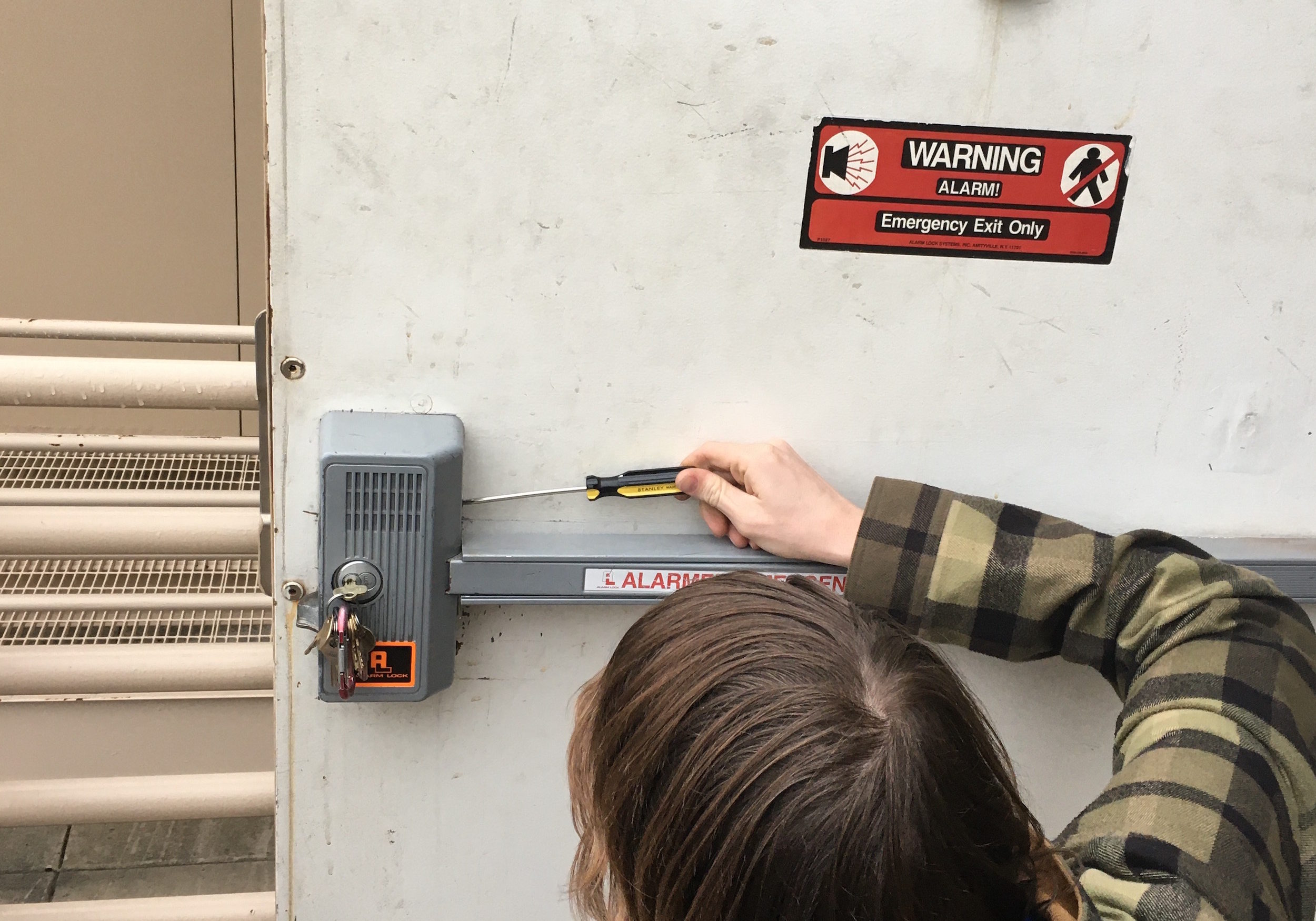 fixing a panic bar on a warehouse door